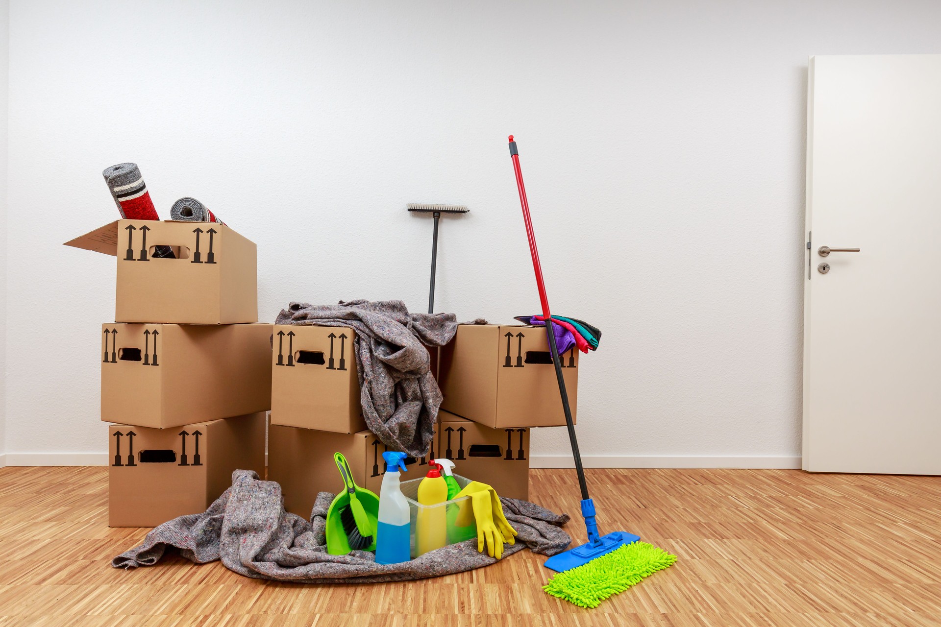 Clean, white room with cartons and cleaning tools